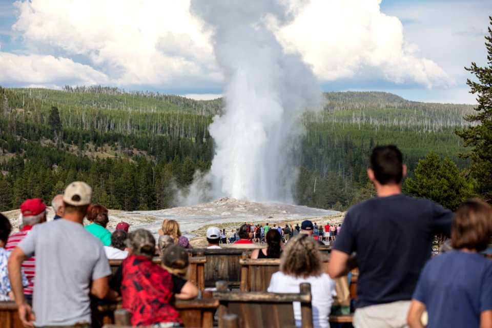 People watching Old Faithful erupt from the Old Faithful Inn (2) photo