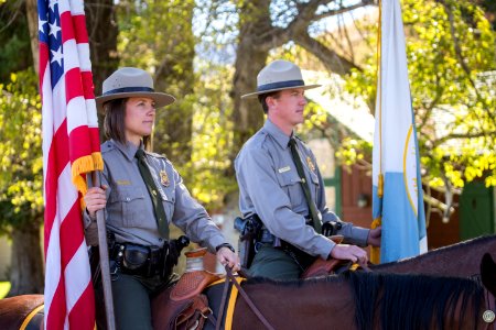 Jackie Sene and Dan Kowalski, members of Yellowstone's Color Guard, deliver the flags during a naturalization ceremony in Mammoth Hot Springs.