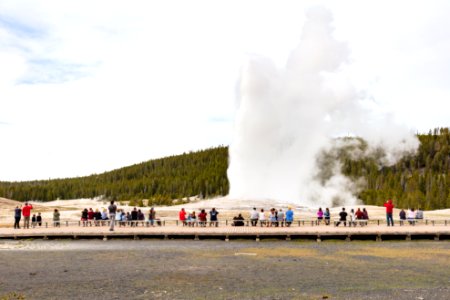 Visitors watch an Old Faithful Eruption Opening day 2020 (2) photo