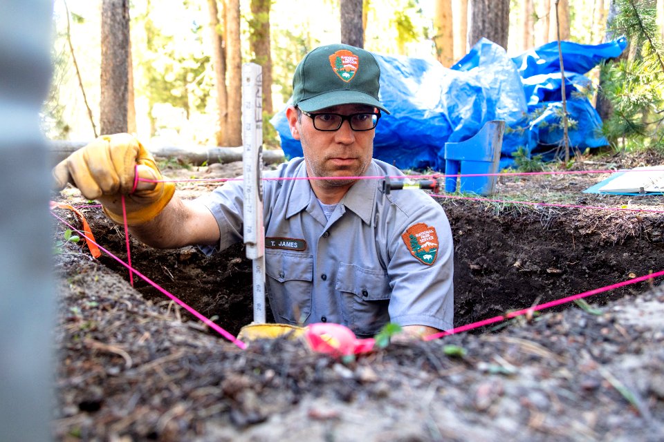 Cultural resource specialist Tom James performing measurements in an excavation test plot