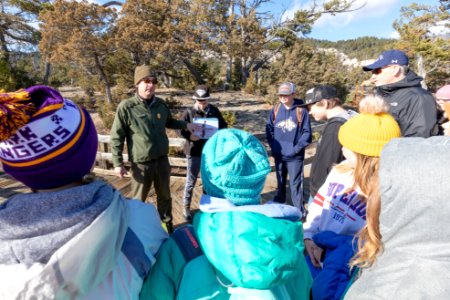 Ranger Mike talks about early visitation to the park with a school group photo