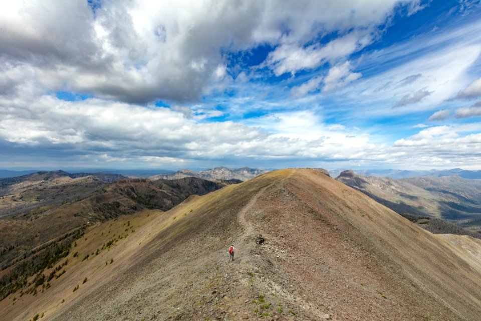Hiker exploring the ridge of Avalanche Peak