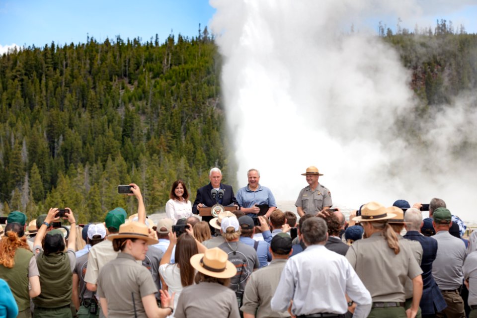 Vice President Mike Pence speaks to a crowd in front of an Old Faithful eruption with the Second Lady, Secretary David Bernhardt, and Superintendent Cam Sholly