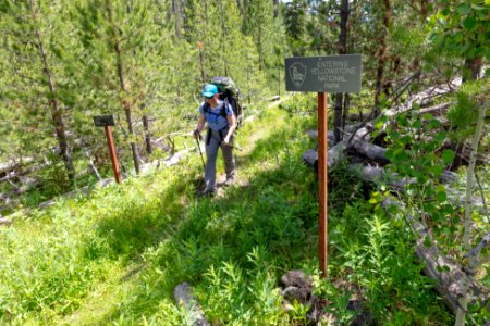 Backpacker crossing the Absaroka Beartooth Wilderness boundary