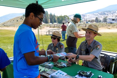 Ranger Jeff hands back a signed Junior Ranger booklet photo