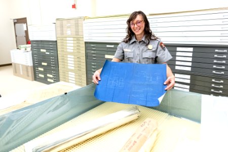 Kimberlee Roberts, Archives Technician, holding up a "relaxed" map after spending time in the humidification chamber