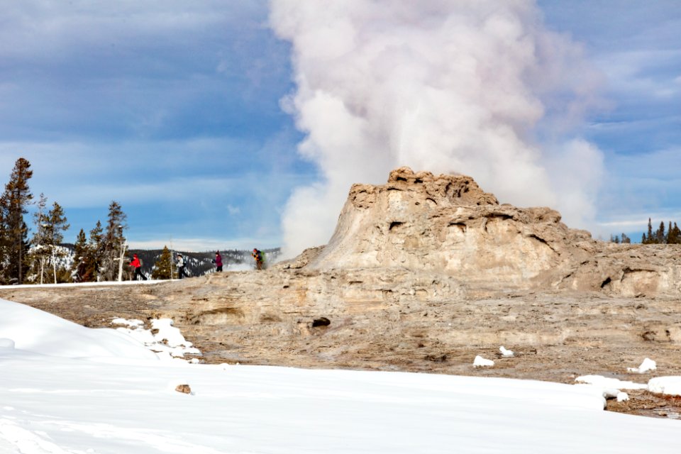 Skiers on the boardwalks near Castle Geyser