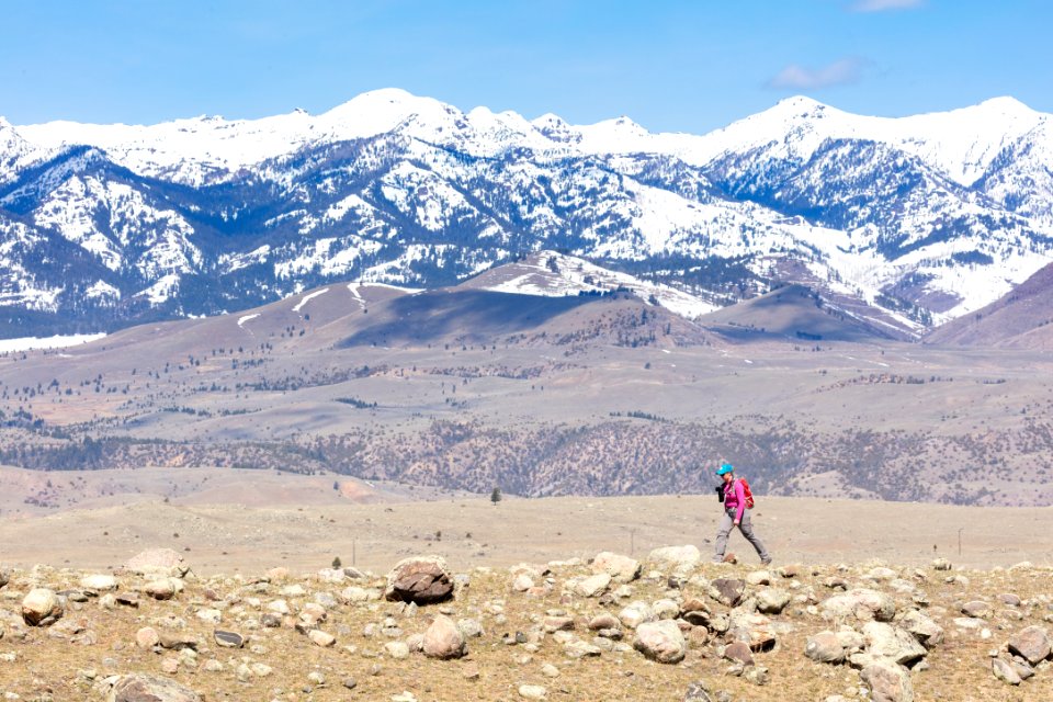 A hiker with the Gallatin Range in the distance