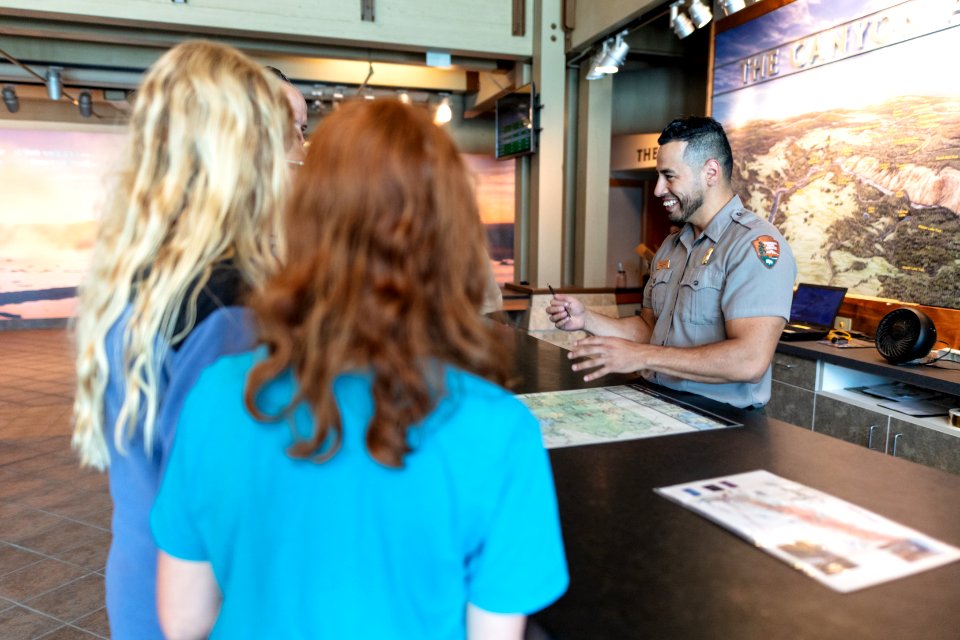 Ranger Francisco chats with people at the Canyon Visitor Education Center