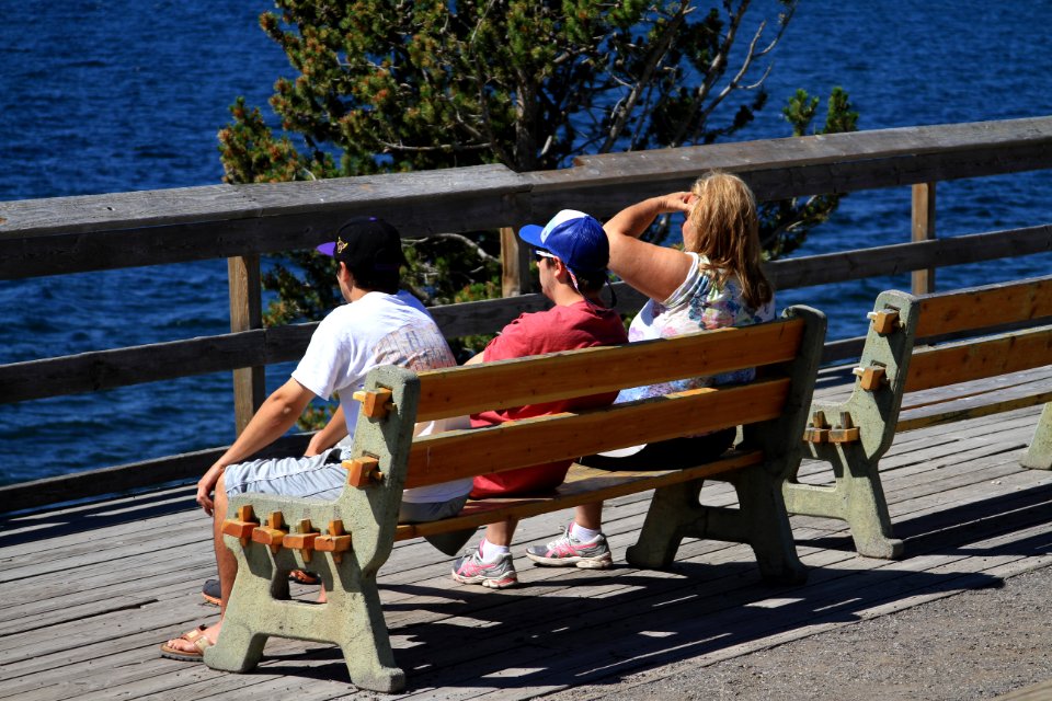 Lake Hotel, visitors sitting on bench looking out at lake