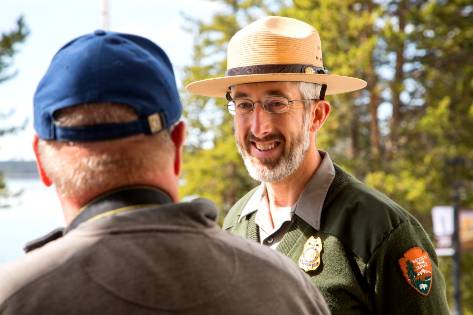 A law enforcement ranger talks with a visitor