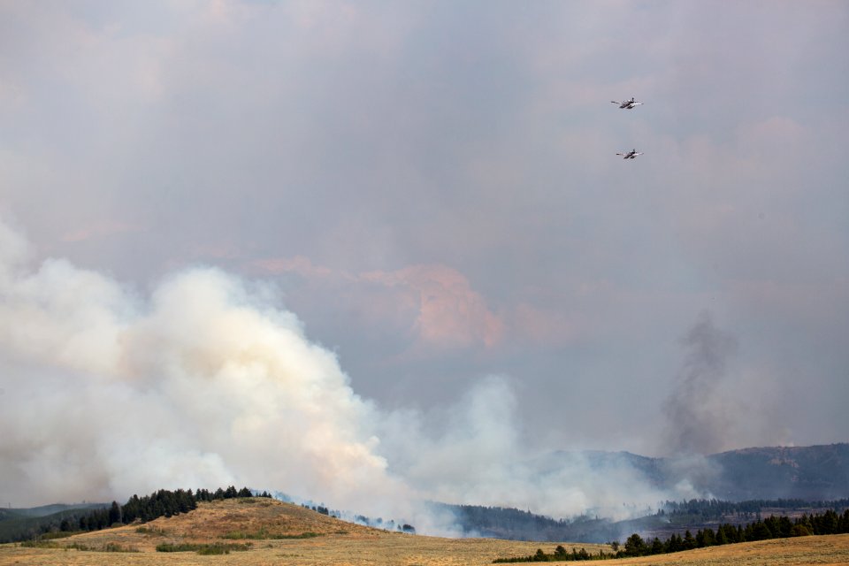 A pair of water-scooping "Fire Bosses" on their way to drop water on the Maple Fire.