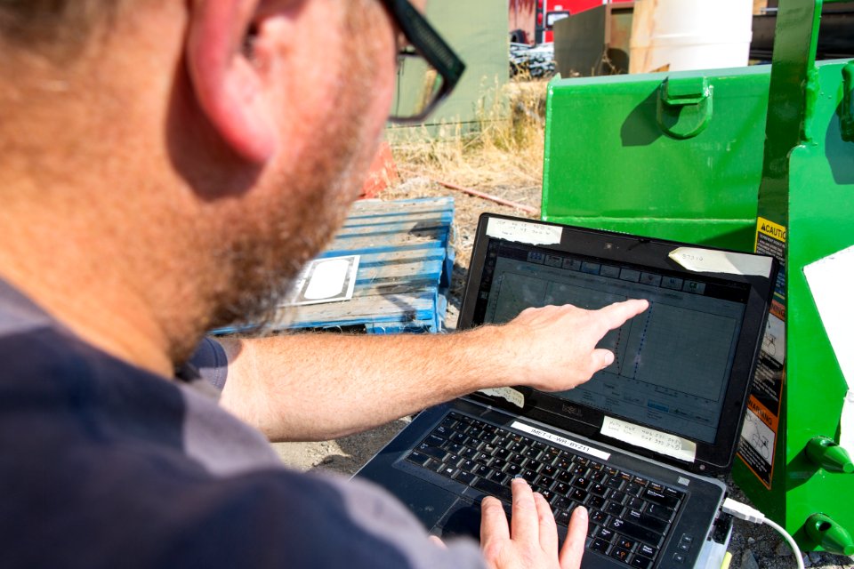 Incident Meteorologist Dan Borsum tracks the flight of a weather balloon