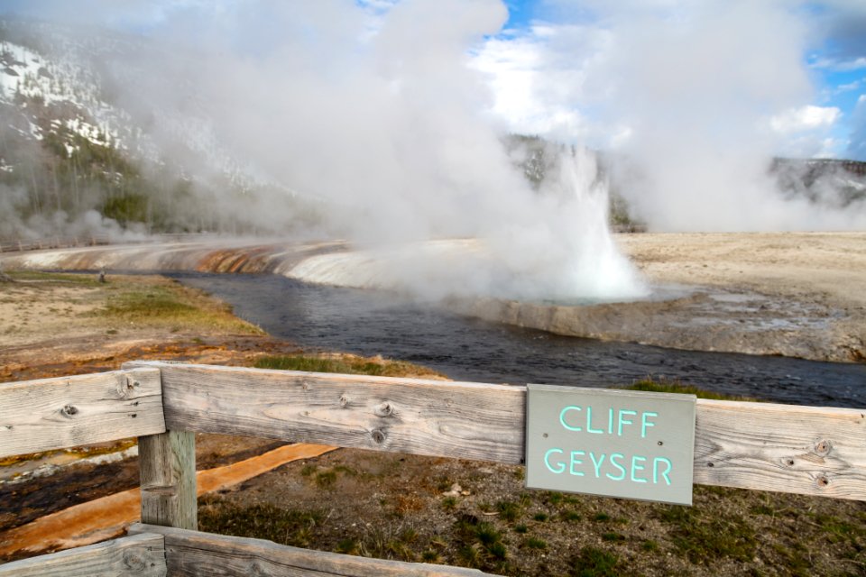 Cliff Geyser (with sign) erupts into Iron Creek