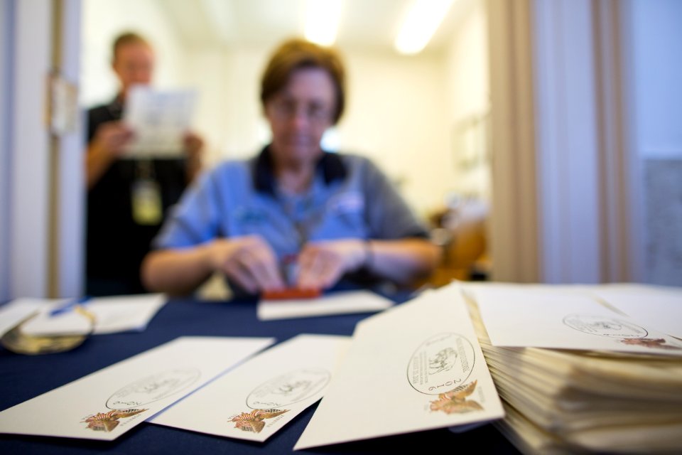 Postal employees issue the Centennial cancellation stamp at Mammoth Hot Springs