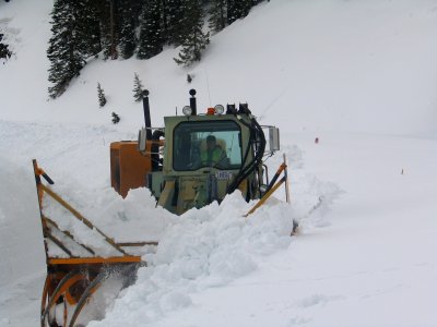 Brett Athas in the Hough loader pushing snow that's above the head photo