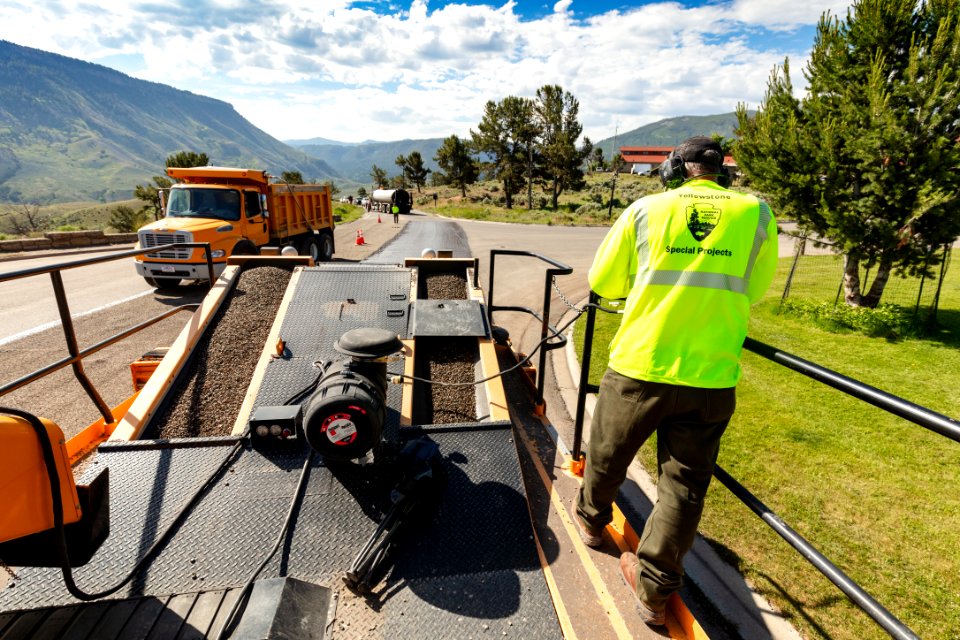 Eyeing the asphalt line to guide the chip spreader