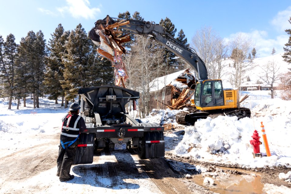 Loading debris from a demolished building in YACC Camp