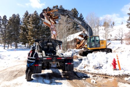 Loading debris from a demolished building in YACC Camp photo