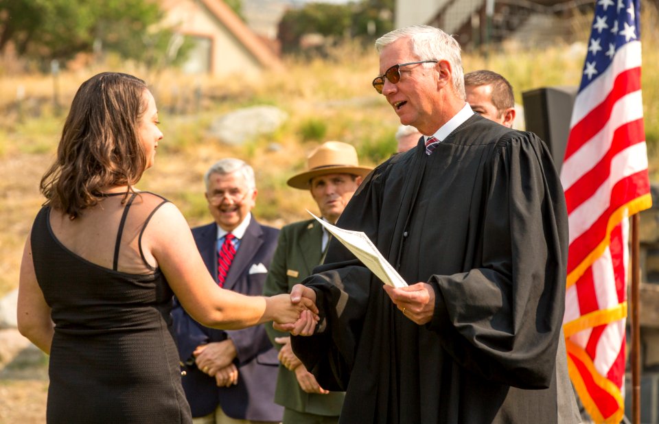 The Honorable Mark L. Camrman contratulates a new U.S. citizen at a naturalization ceremony
