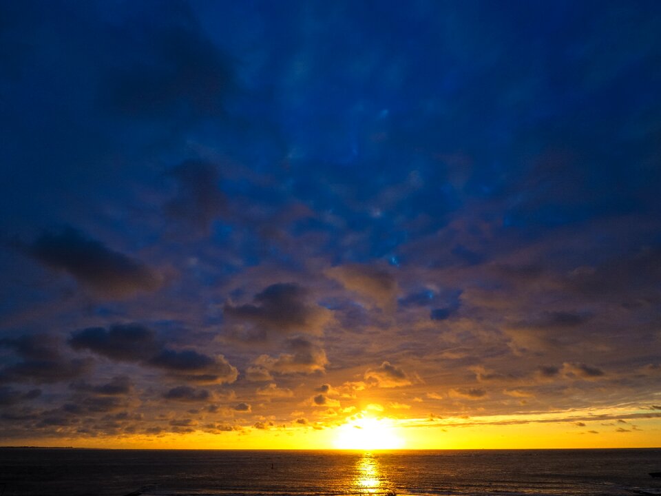 Setting sun clouds beach