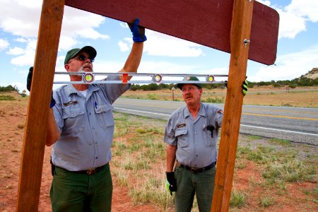 Larry Davis and  Roger Lock installing a new sign.