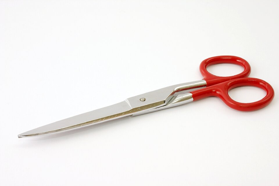 A pair of scissors cutting isolated