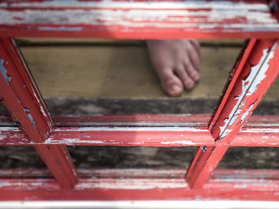 Peeling paint, reflected foot