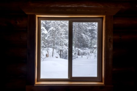 Snowy view from inside a public use cabin.