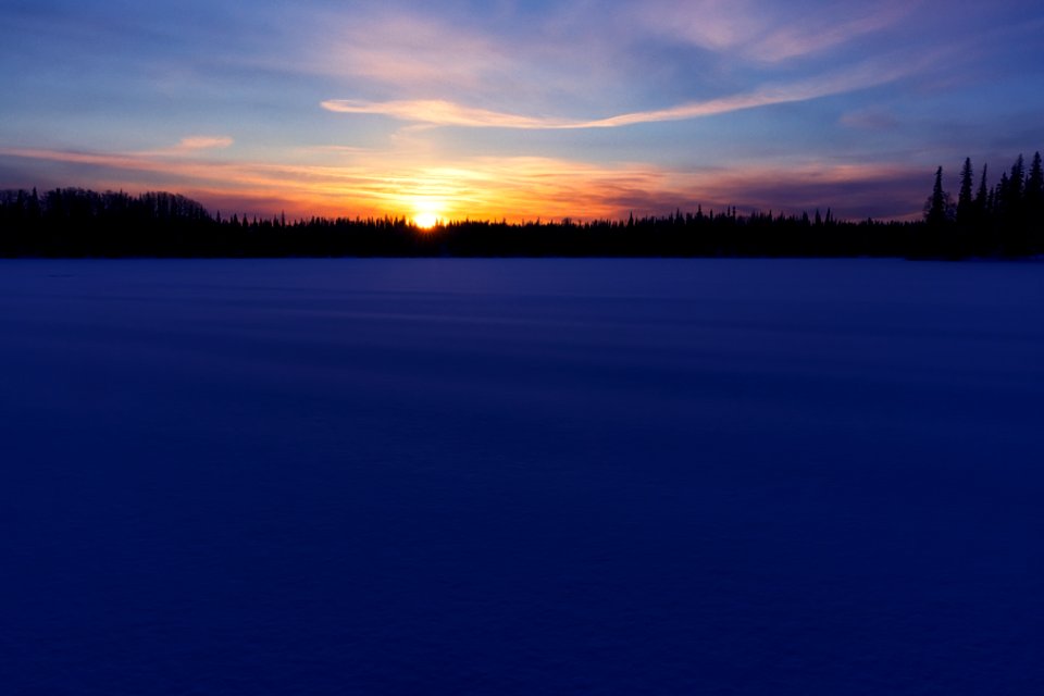 Sunrise over the snowy lake.