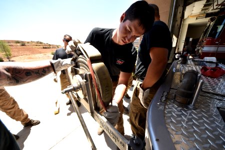 Rolling hose using the engine (Lisa Cox/USFWS)