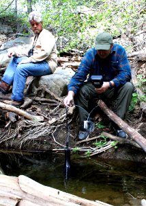 Chris Dellith, a senior fish and wildlife biologist with the USFWS, watches as John O'Brien, senior environmental scientist, supervisory, with the CDFW, tests water quality to confirm its viability for unarmored threespine sticklebacks.