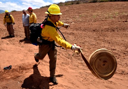 Firefighter Aaron Wilson performing start of single hose lay (Lisa Cox/USFWS)