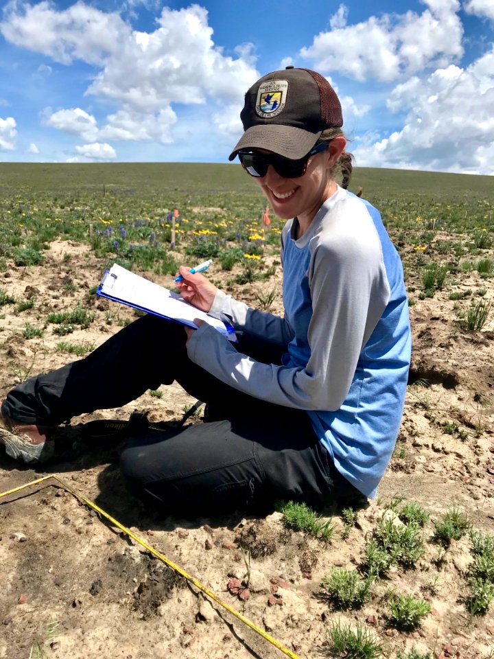 Sarah Kulpa, FWS ecologist and botanist, collects data at the Martin Fire native seed experiment