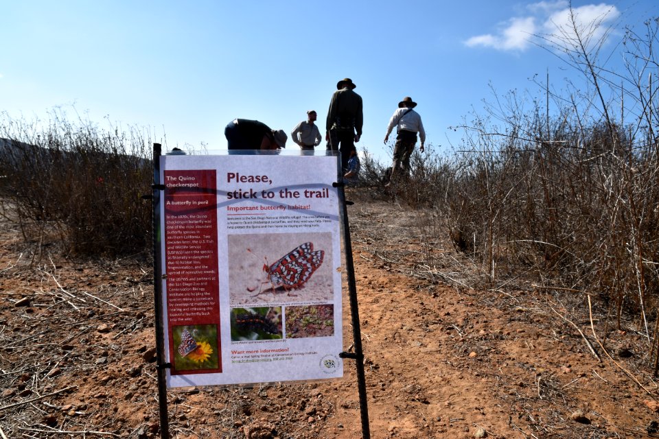 Educational sign to encourage trail users to stay on the trail
