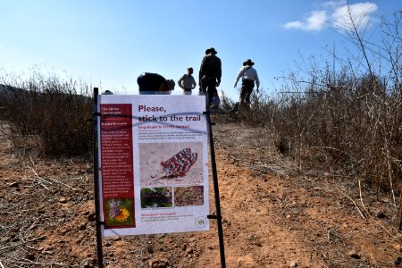 Educational sign to encourage trail users to stay on the trail