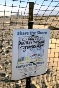 A share the shore sign on a beach near Oxnard, California.