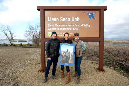 Family photo in front of sign