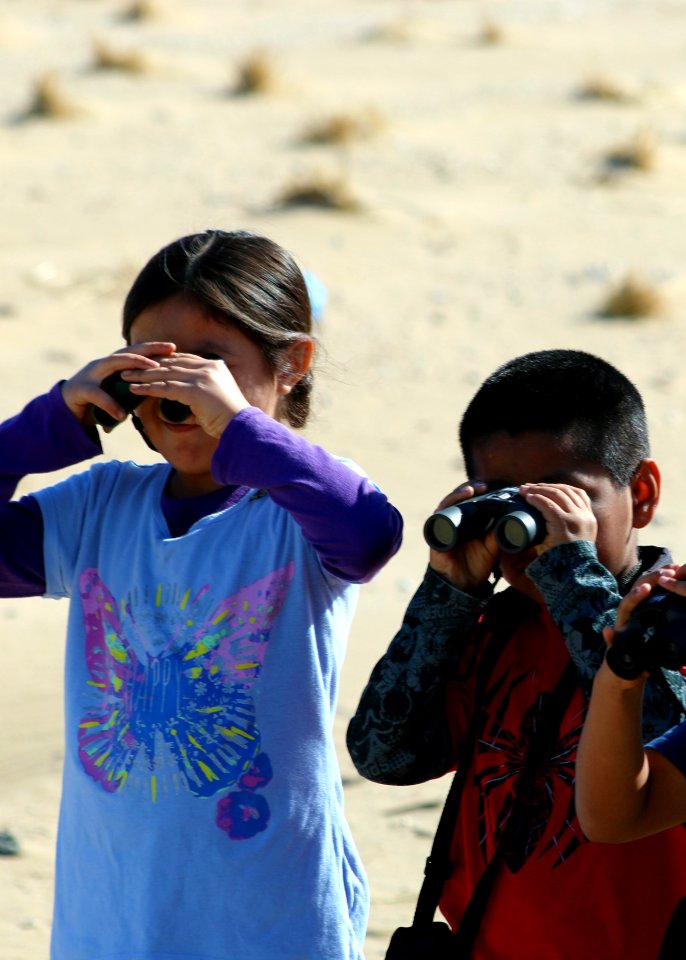 MONTEREY, Calif. (April 1, 2014) Second graders from Santa Rita Elementary School in Salinas use binoculars for the first time to watch birds at Monterey State Beach.