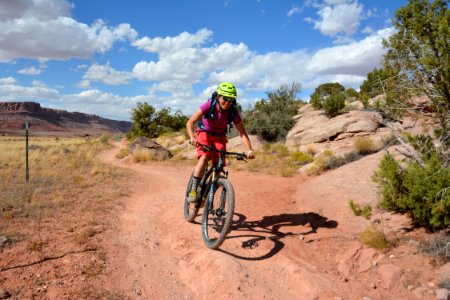 A woman bikes on the Bar M Trails