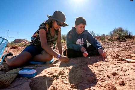 Documenting dino tracks near Moab, UT. Photo by Eric Delphenich