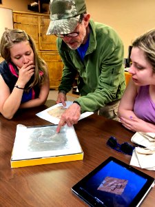 SLCSE outdoor exploration teacher Cavette Eaton reviews 3-D dino tracks with BLM interns Whitney May and Sarah Hancey. Moab, UT. Photo by BLM-UT