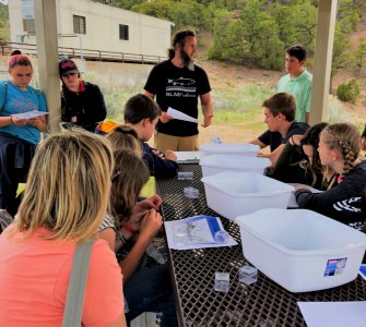 BLM Vernal FO Biologist Jerrad Goodell explains aquatic science at Flaming Gorge STEM Day at FlamingGorge Dam, UT. Photo by BLM UT