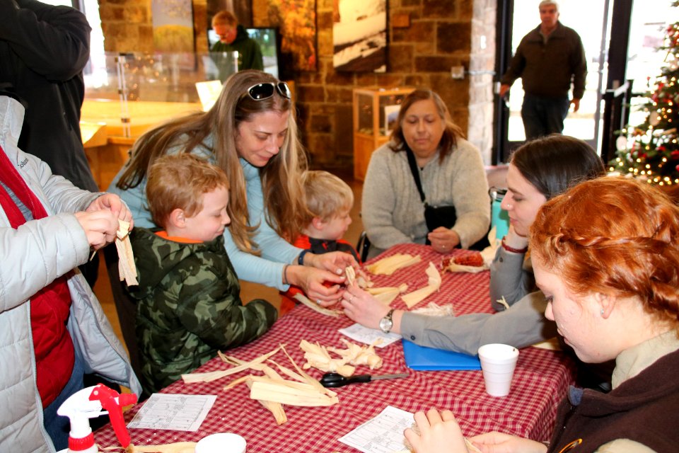 Visitors making cornshuck dolls, December 2017--Warren Bielenberg