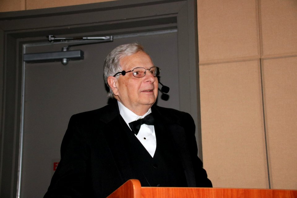 Emcee announcing next performance, December 2017--Warren Bielenberg