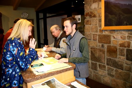 Volunteer Merwyn Borders and AmeriCorps Crew Member Erin Waddell assist visitors at the 2018 Festival of Christmas Past, December 8, 2018--Warren Bielenberg