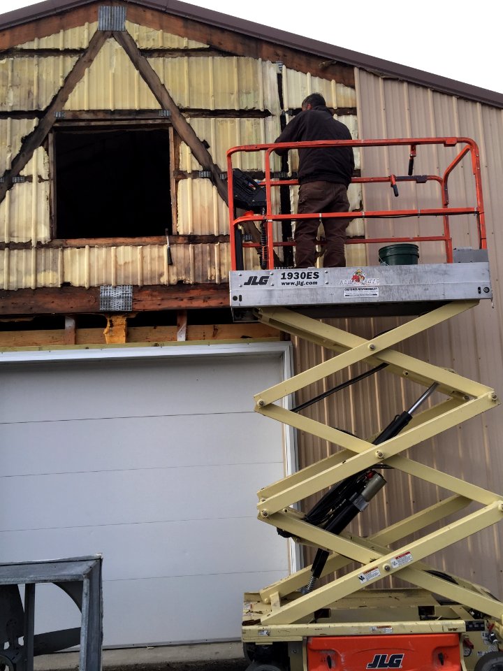 Replacing siding on Sturgeon Building
