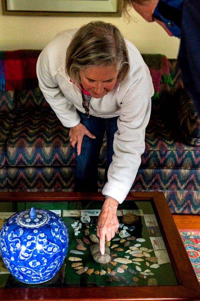 Marilyn shows off artifacts found on their property, arrowheads, tools, and more