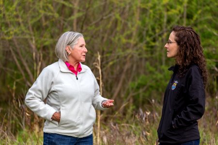 Marilyn Spong walks with Megan Lang (USFWS) around the restored wetland