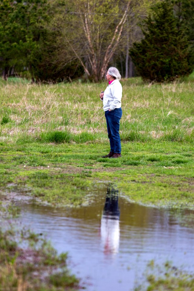 Marilyn Spong watches for signs of wildlife near the restored wetland